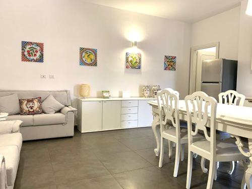 a kitchen and living room with a table and chairs at Le Sorelle Apartment in Agrigento