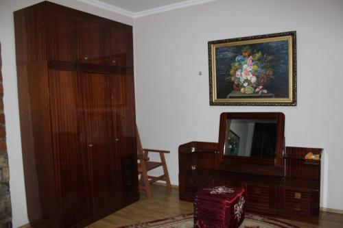 a living room with wooden furniture and a mirror at Kera in Tsinandali