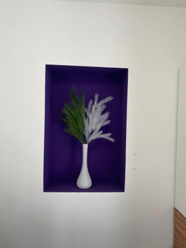 a vase with a plant on a wall at Kathis Juwel in Seeboden