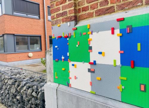 a wall made out of legos next to a building at Les chambres atypiques de Nico Bush - Parking sécurisé vélos in Tournai