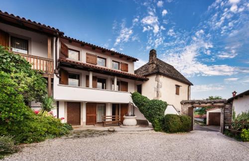an exterior view of a house with a large building at Hiša Orel (Orel House) in Križ