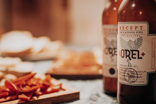 a bottle of beer sitting next to a pile of fries at Hiša Orel (Orel House) in Križ