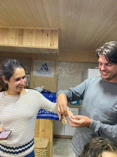 a man and a woman shaking hands in a store at MetiTsa in Jut'a
