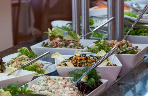 a buffet of salad dishes on a table at Apollo Beach in Faliraki