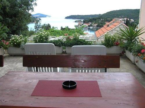 a bowl on a red napkin on a wooden table at Apartments Radis in Zaton
