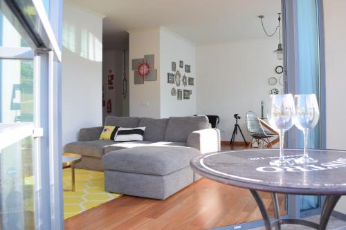 a living room with a couch and a table with wine glasses at Angel's Apartment in Funchal