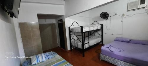 a small room with two bunk beds in a room at HOTEL CASA COLONIAL in San Antonio del Táchira