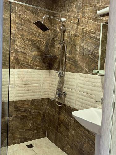 a bathroom with a shower and a sink at nikani1 in Borjomi