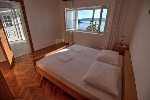 a large bed in a room with a window at Kaka in Sveti Juraj