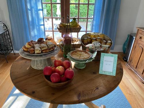 a wooden table with plates of food on it at Aria & Mare Hamptons in Hampton Bays