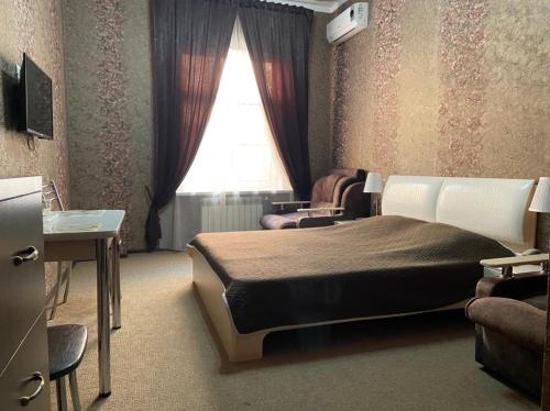 a bedroom with a bed and a window at Anzhelika Hotel in Rostov on Don