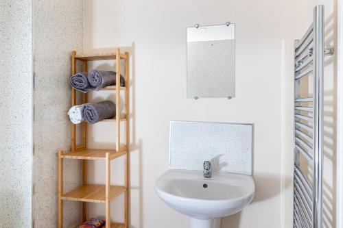 a bathroom with a white sink and a toilet at Finest Retreats - Number Seven in Skipton