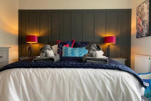 a bedroom with a bed with two dogs on it at WESTREACH Filey - a 4 Bedroom, all en-suite sleep 8 Townhouse in Filey