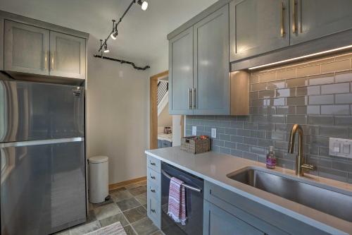 a kitchen with gray cabinets and a sink at Modern Evergreen Duplex Directly Off I-70! in Idaho Springs