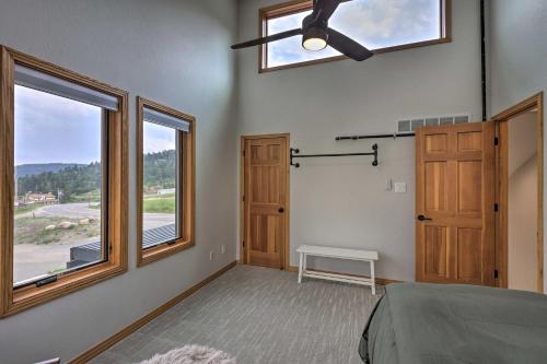 a bedroom with a ceiling fan and a window at Modern Evergreen Duplex Off I-70 with Mountain Views in Idaho Springs
