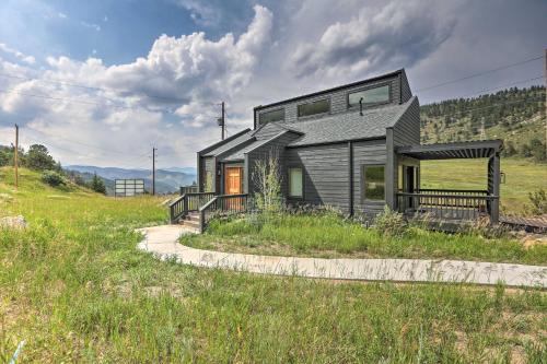 a house in the middle of a field at Modern Evergreen Duplex Off I-70 with Mountain Views in Idaho Springs