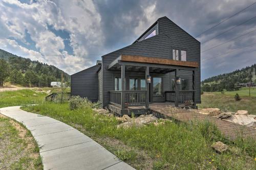 a black house on a hill with a sidewalk at Modern Evergreen Duplex Off I-70 with Mountain Views in Idaho Springs