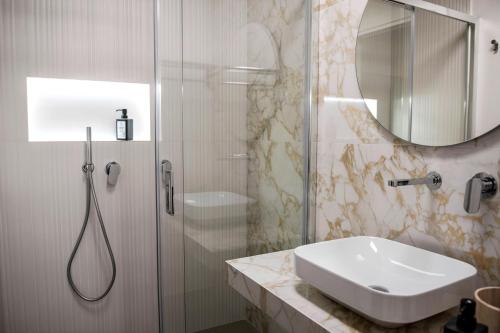 a bathroom with a sink and a shower at Case vacanza Puccini in Alcamo