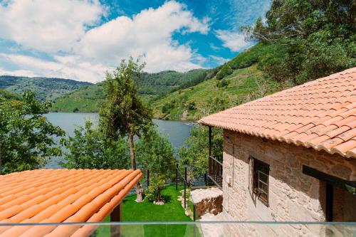 a house with a view of a lake and mountains at Casa Escondida Aveiga in Chantada
