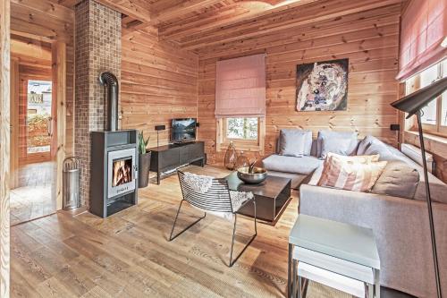 a living room with a couch and a fireplace at Chalet Dacha mit finnischer Sauna in Zell am See