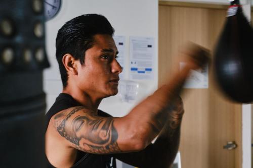 a man with tattoos on his arm pointing at something at Hotel NYX Cancun in Cancún