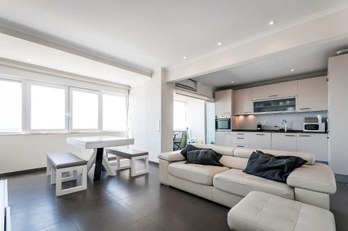 a living room with a couch and a table at Amazing Apartment in Costa da Caparica in Costa da Caparica