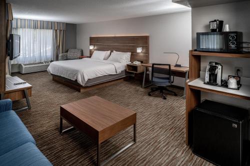 a hotel room with a bed and a desk at Holiday Inn Express and Suites Pikeville by IHG in Pikeville