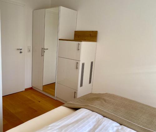 a bedroom with a bed and a cabinet in it at Ferienzimmer Olli Koch in Reken