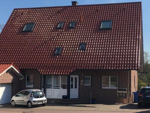 a house with a car parked in front of it at Ferienzimmer Olli Koch in Reken