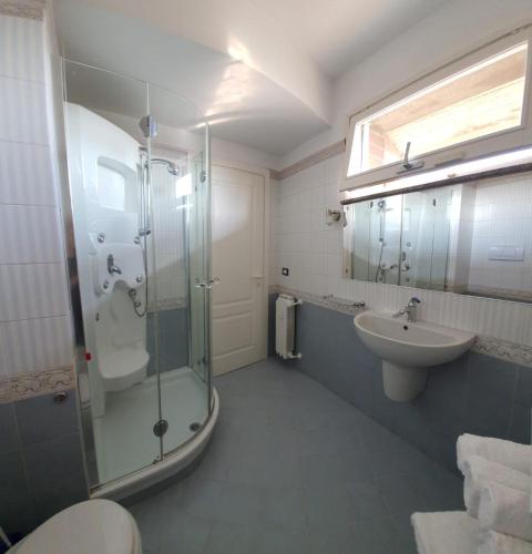 a bathroom with a glass shower and a sink at B&B METRO' in Perugia