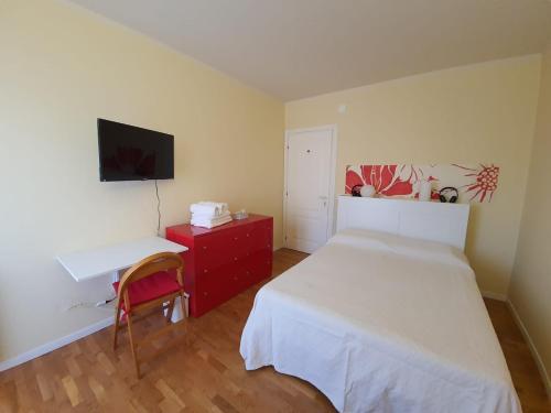 a bedroom with a bed and a desk and a tv at B&B METRO' in Perugia