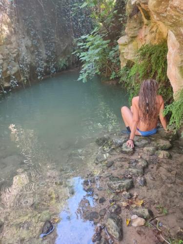 a woman in a bathing suit sitting in a pool of water at casa malferit in Alcoleja