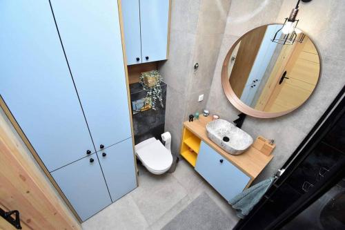 La salle de bains est pourvue d'un lavabo et d'un miroir. dans l'établissement Apartament Blue Bastion Wałowa 23c z klimatyzacją i miejscem parkingowym w podziemnym parkingu, à Gdańsk