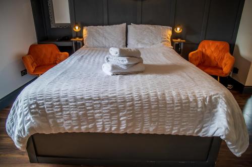 a bedroom with a large bed with towels on it at Caledonian Canal Studio in Inverness