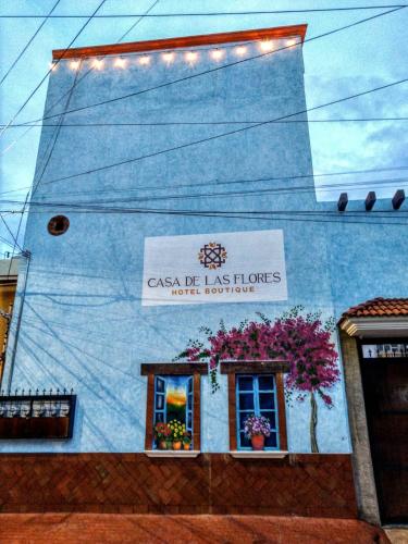 a blue building with flowers on the side of it at Casa de las flores Hotel Boutique in Huajuapan de León