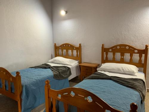 a room with two beds and two night stands at El Remanso in Pájara