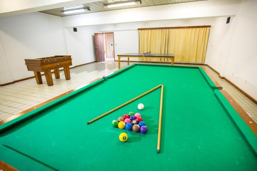 a pool table with balls on it in a room at Monte Pascoal Praia Hotel in Porto Seguro