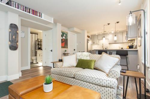 a living room with a couch and a table at Madison Park Seattle with Outdoor Private Garden and Grill 1BR 1BA in Seattle