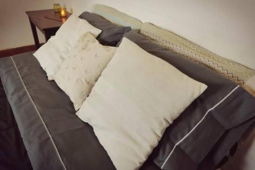 a bed with two pillows on it with a table at CASONA DE LORETO - alquiler temporario- in Azul