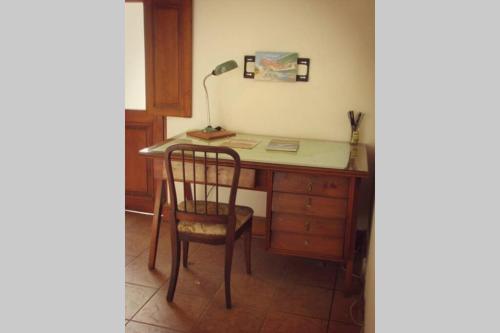 an office with a desk with a chair and a lamp at CASONA DE LORETO - alquiler temporario- in Azul