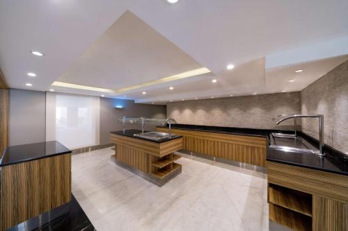 a kitchen with a sink and a counter at SAS Residence & Hotel Dhahran in Al Khobar