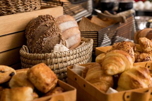a display of breads and pastries in baskets at SAS Residence & Hotel Dhahran in Al Khobar