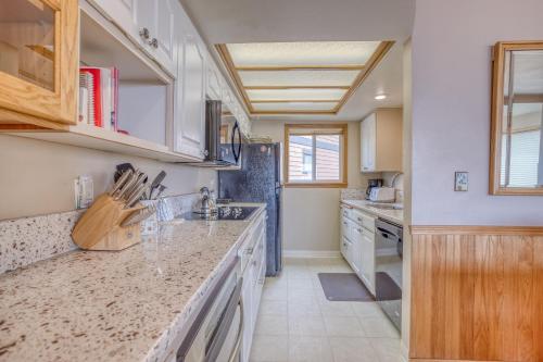 a kitchen with white cabinets and a counter top at Breakers Beach House 9 - Meredith Lodging in Neskowin