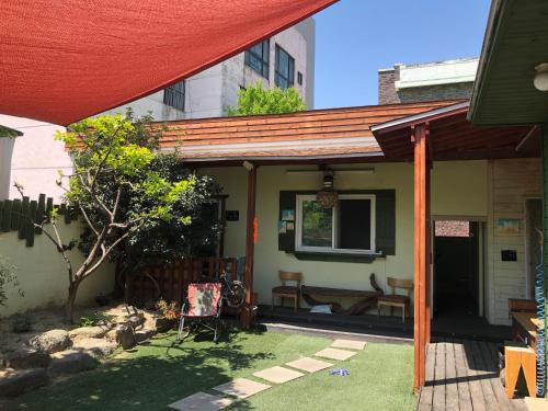 a house with a porch with a wooden roof at Gyeongju Momojane Guesthouse in Gyeongju