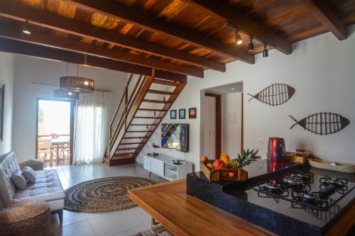 a kitchen and living room with a stove top oven at Reserva Barra Grande in Barra Grande