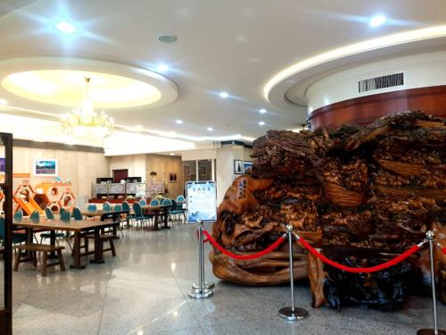 a large room with tables and chairs and a large building at Chuan Fu Hotel in Fengyuan