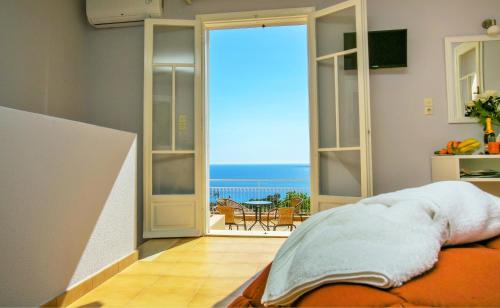 a room with an open door with a view of the ocean at Sunset Paradise in Lassi