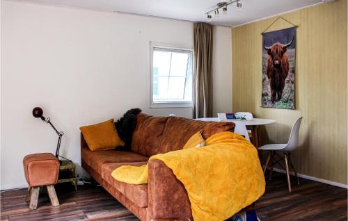 a living room with a brown couch and a table at 2 Bedroom Gorgeous Home In Rheezerveen in Rheezerveen