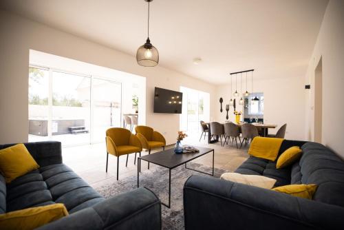 a living room with a couch and a table at 1oak villa in Vir