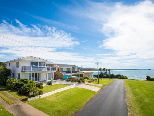 a house on a street with a view of the ocean at 31 McMillan Crescent, Dalmeny in Dalmeny